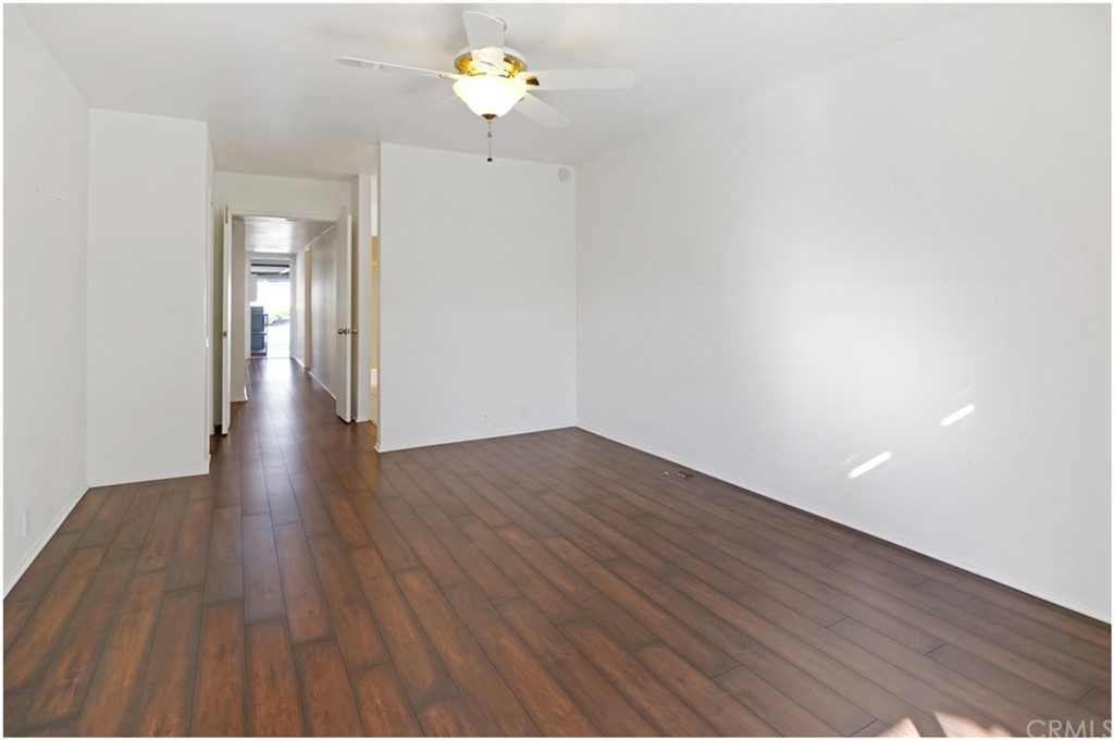 23892 Danzig Bay Dana Point, CA 92629 - Photo 26 of 49 a view of an empty room with wooden floor and a ceiling fan