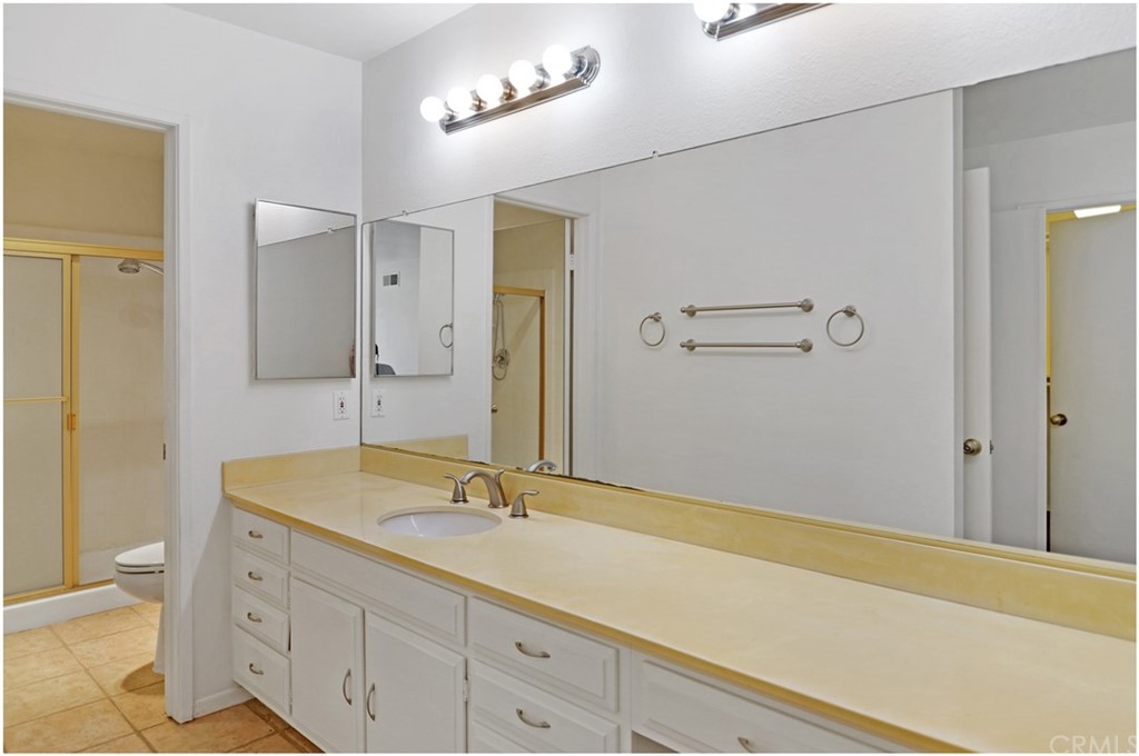 23892 Danzig Bay Dana Point, CA 92629 - Photo 27 of 49 a bathroom with a sink a mirror and a shower