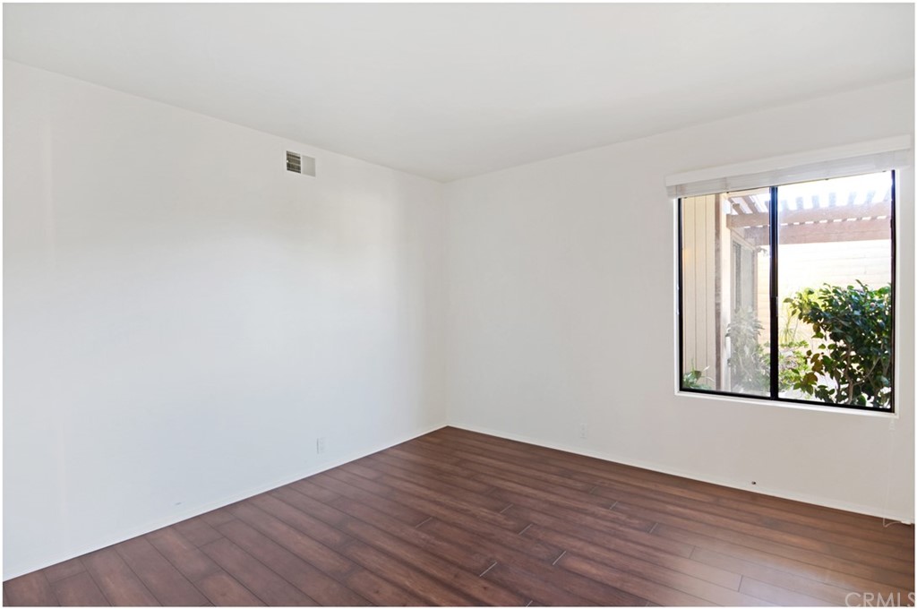 23892 Danzig Bay Dana Point, CA 92629 - Photo 30 of 49 an empty room with wooden floor and windows