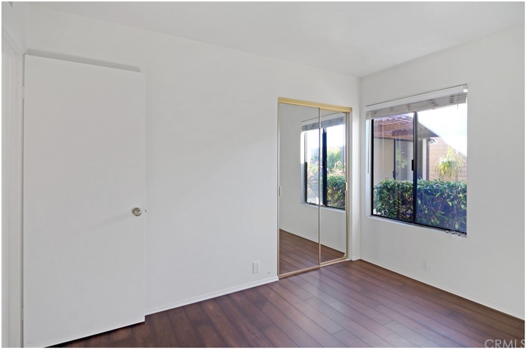 23892 Danzig Bay Dana Point, CA 92629 - Photo 32 of 49 an empty room with wooden floor and windows
