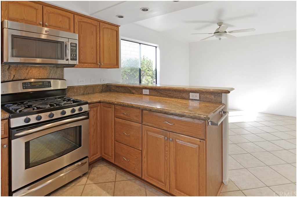 23892 Danzig Bay Dana Point, CA 92629 - Photo 9 of 49 a kitchen with granite countertop a stove sink and microwave