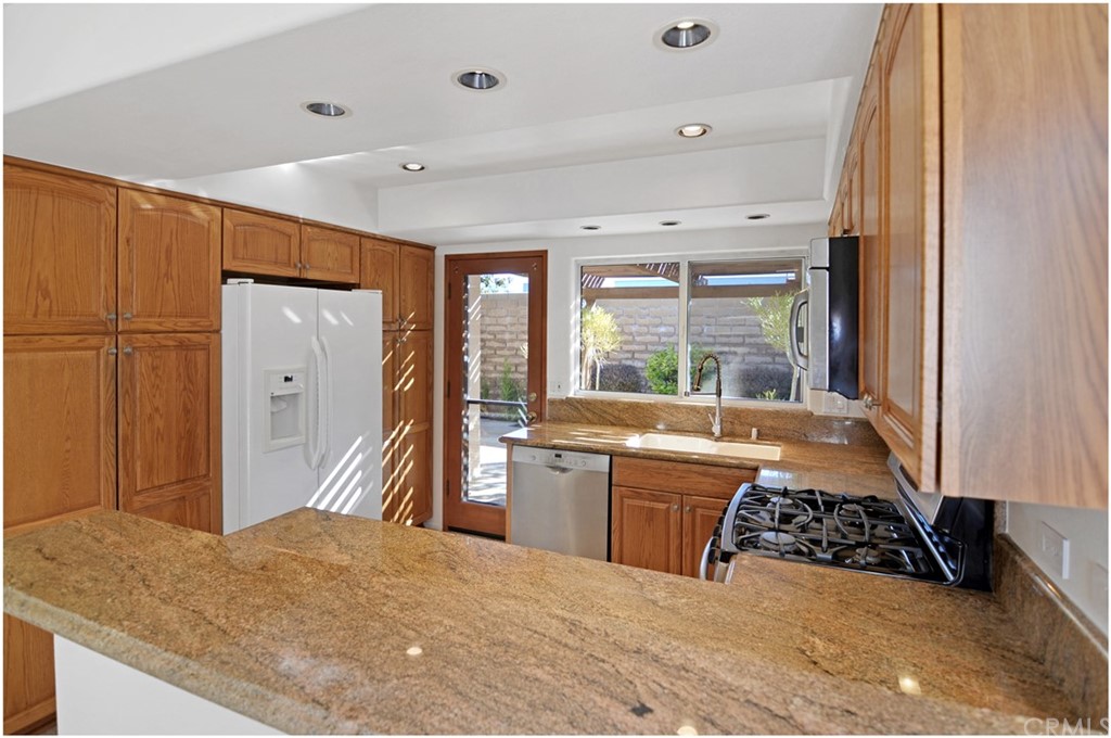 23892 Danzig Bay Dana Point, CA 92629 - Photo 10 of 49 a large kitchen with a stove and large window