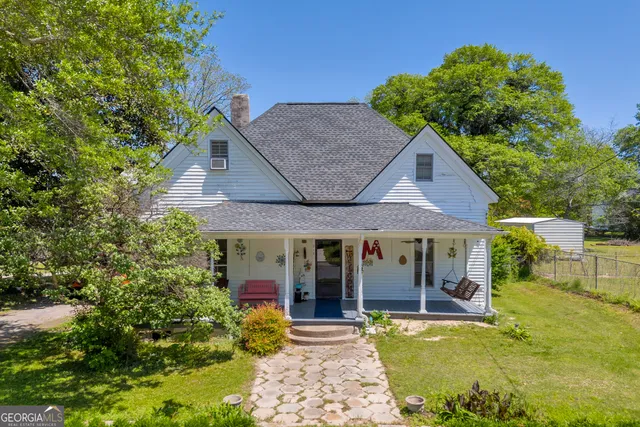 a front view of a house with a yard table and chairs