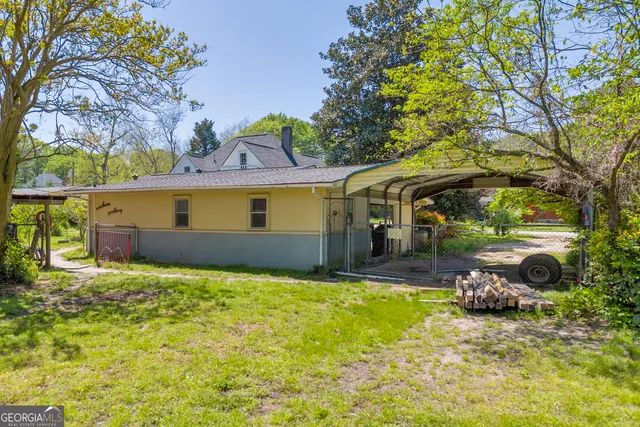an aerial view of house with yard swimming pool and outdoor seating