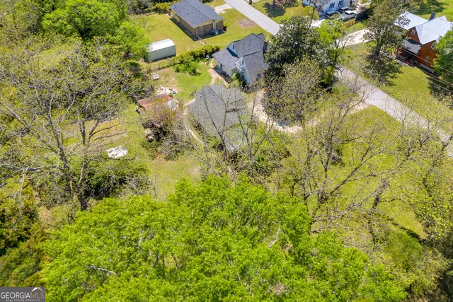 a bedroom with a bed a fireplace and a large window
