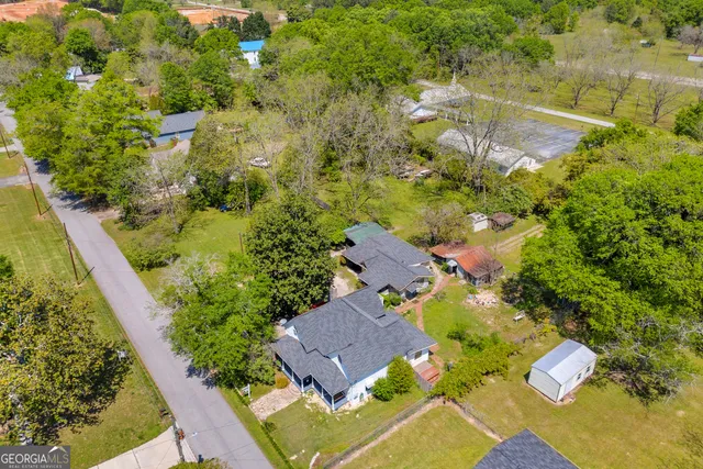 a bedroom with furniture a flat screen tv and a fireplace