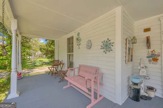 a view of staircase with lots of frames on wall and a large window