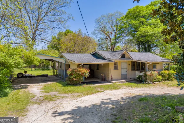 an aerial view of house with yard and trees in the background