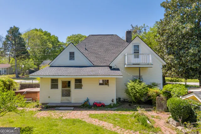 a view of patio with chairs and a table under an umbrella