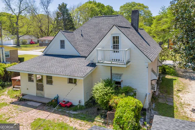 a backyard of a house with table and chairs