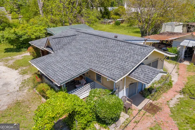 an aerial view of a house with a garden and swimming pool