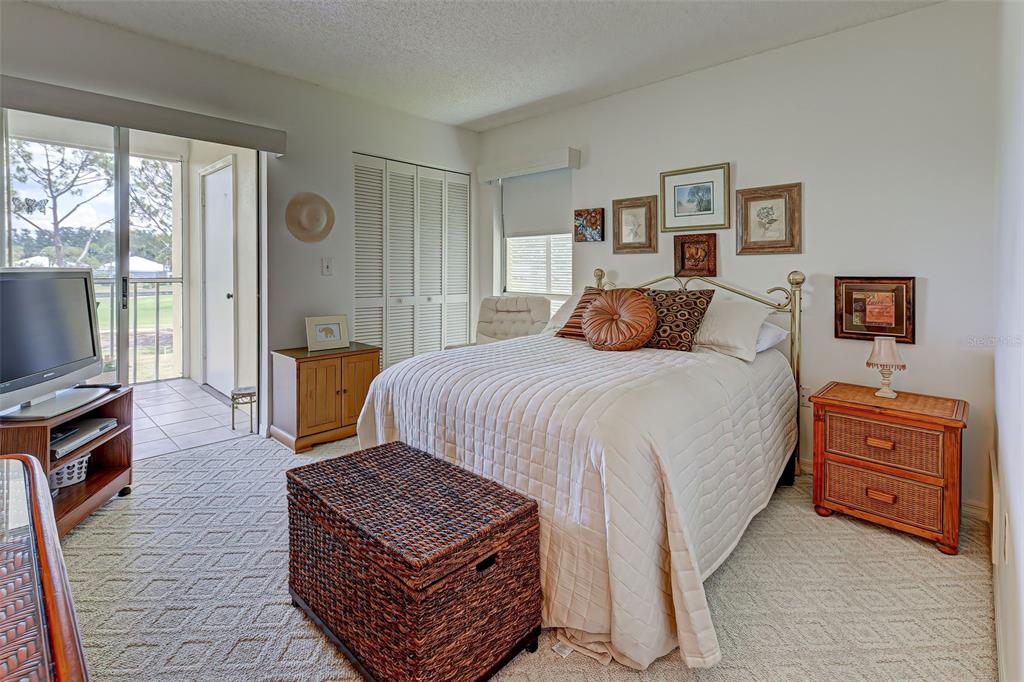 418 Cerromar Court, Unit 261 Venice, FL 34293 - Photo 33 of 76 a bedroom with a bed and wooden floor