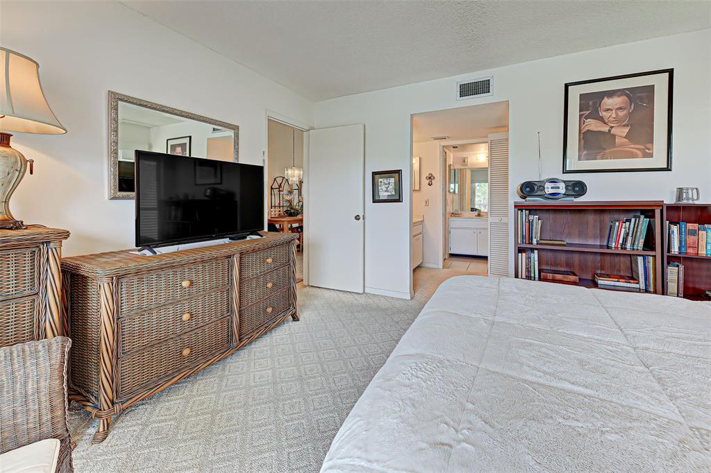 418 Cerromar Court, Unit 261 Venice, FL 34293 - Photo 10 of 76 a bedroom with furniture and a flat screen tv