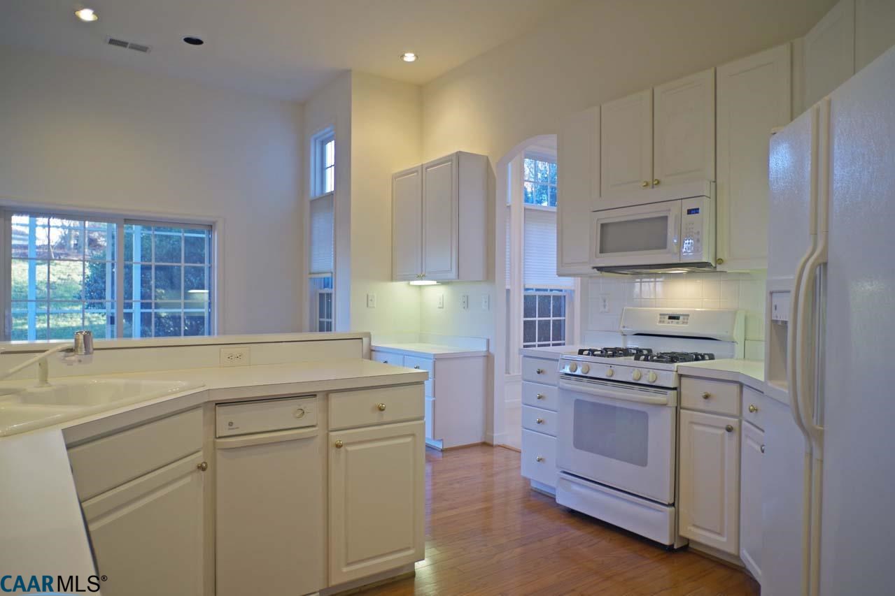 2126 Shepherds Ridge Road Charlottesville, VA 22901 - Photo 19 of 37 a kitchen with white cabinets and stainless steel appliances