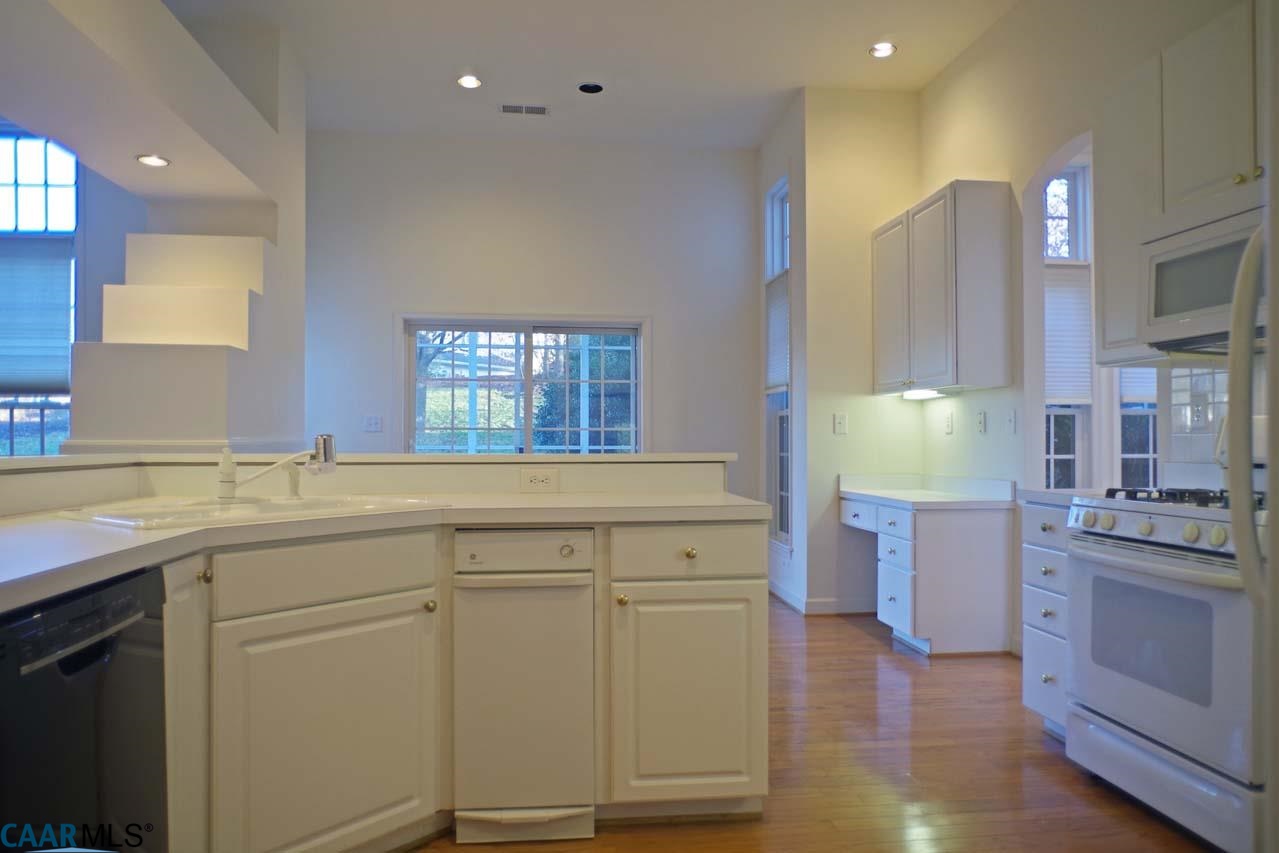 2126 Shepherds Ridge Road Charlottesville, VA 22901 - Photo 20 of 37 a kitchen with white cabinets and sink