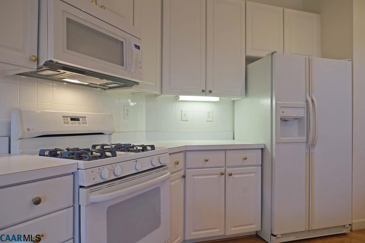 2126 Shepherds Ridge Road Charlottesville, VA 22901 - Photo 21 of 37 a kitchen with white cabinets and appliances