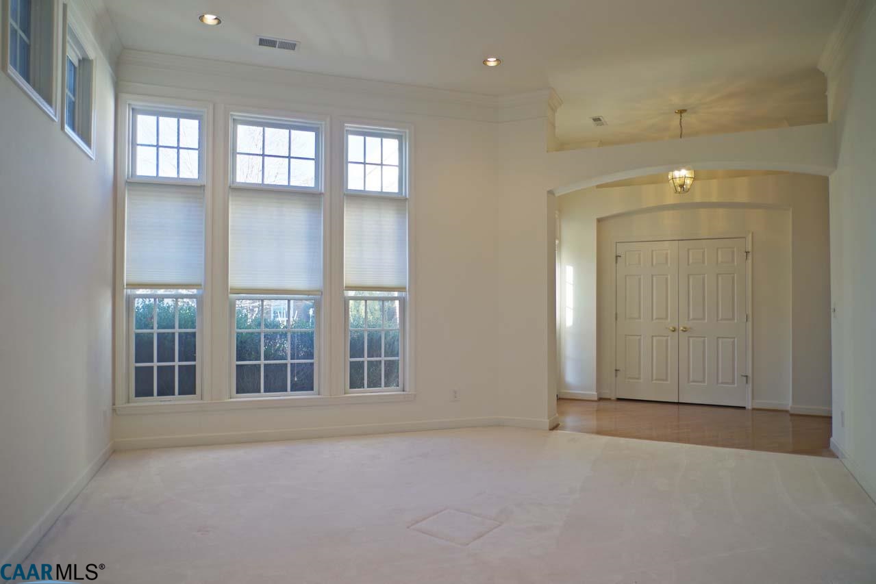 2126 Shepherds Ridge Road Charlottesville, VA 22901 - Photo 6 of 37 an empty room with windows and pillars in it