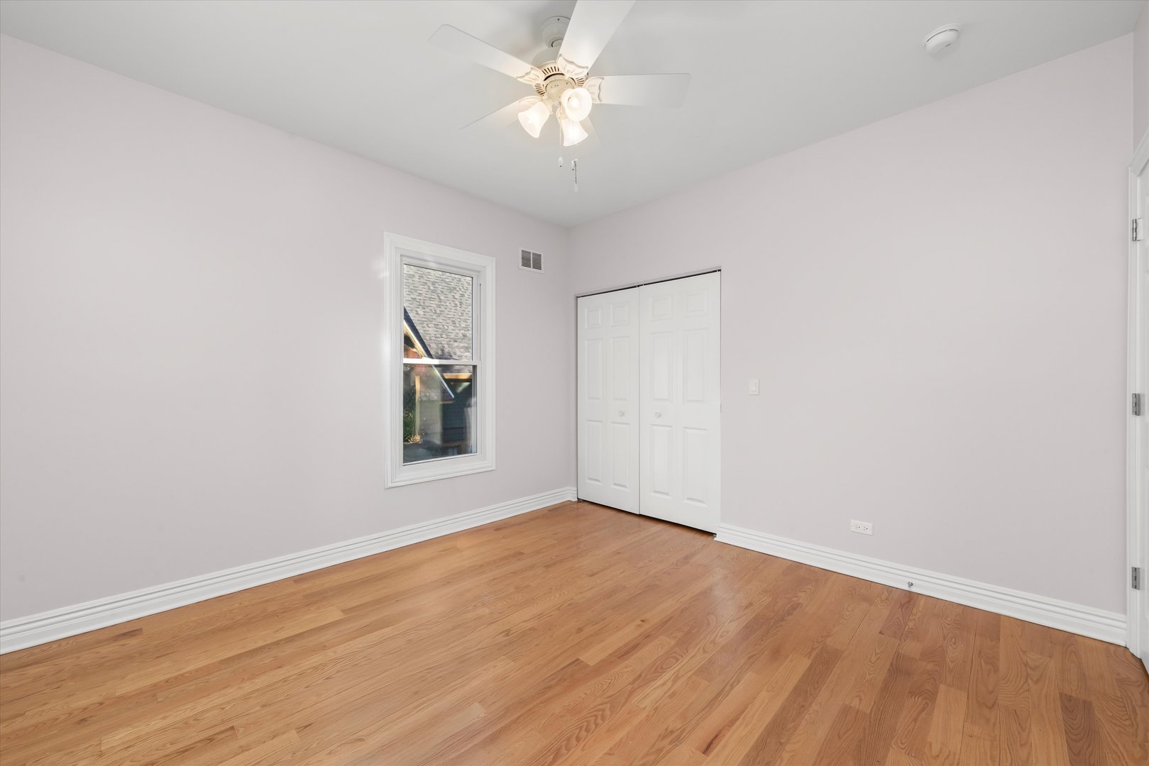197 Herrick Road Riverside, IL 60546 - Photo 15 of 45 an empty room with a window and a ceiling fan
