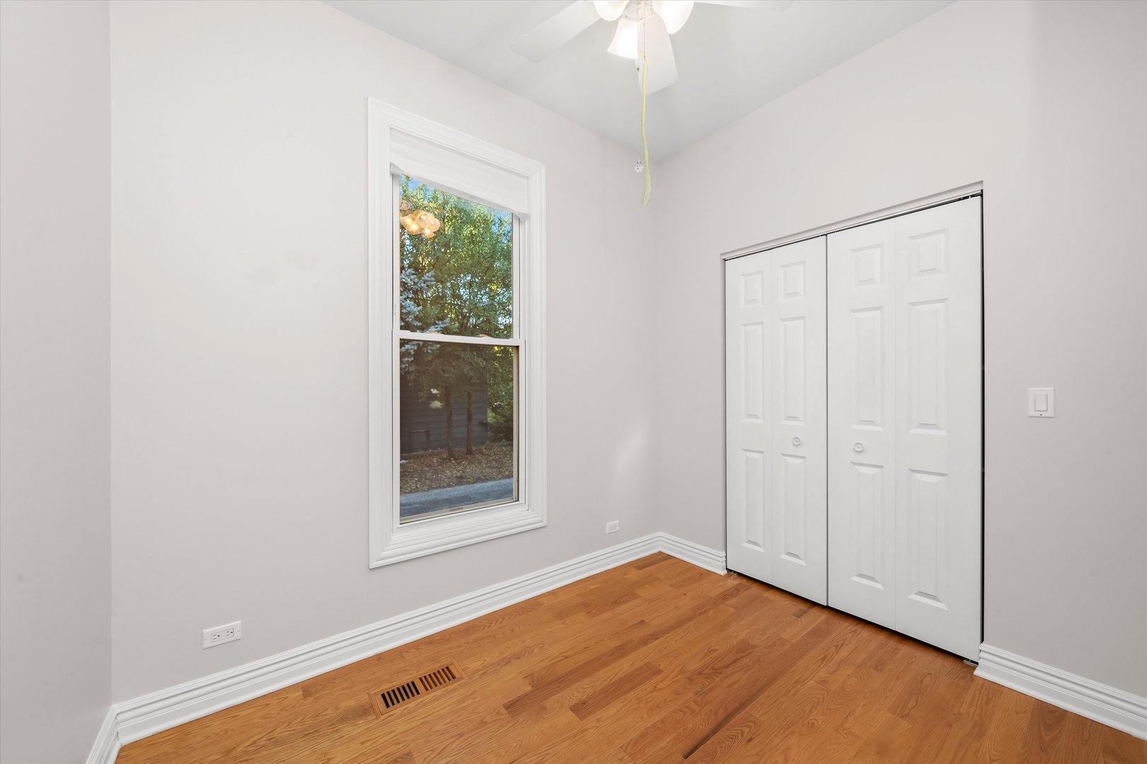 197 Herrick Road Riverside, IL 60546 - Photo 26 of 45 an empty room with a window and chandelier fan