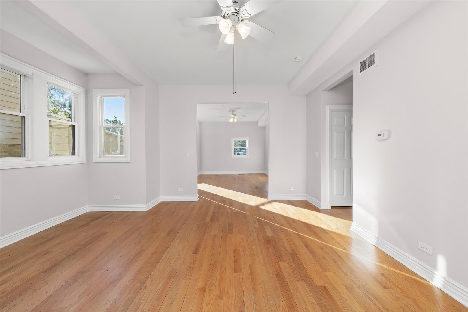197 Herrick Road Riverside, IL 60546 - Photo 3 of 45 a view of an empty room with wooden floor and a window