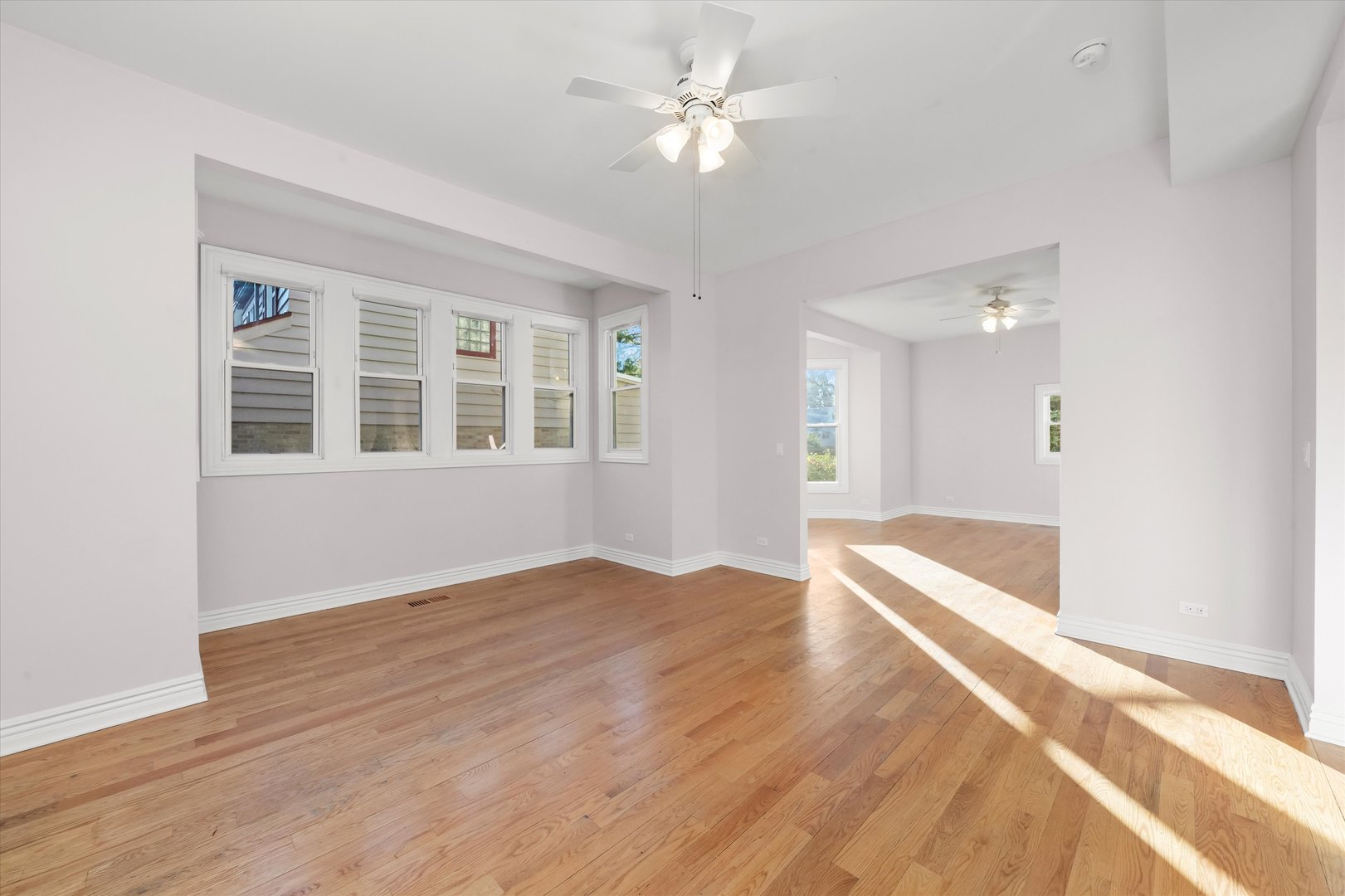 197 Herrick Road Riverside, IL 60546 - Photo 8 of 45 a view of an empty room with window and wooden floor