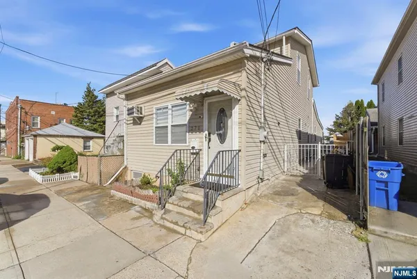 a view of a house with wooden fence
