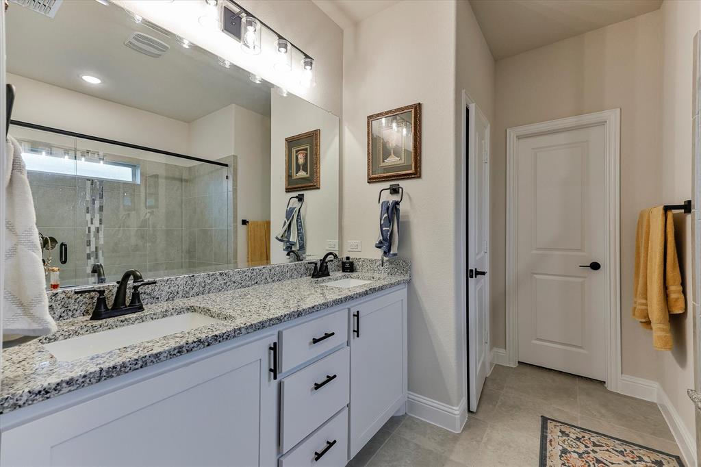 10 Covey Lane Sanger, TX 76266 - Photo 14 of 29 a bathroom with a granite countertop sink and a mirror
