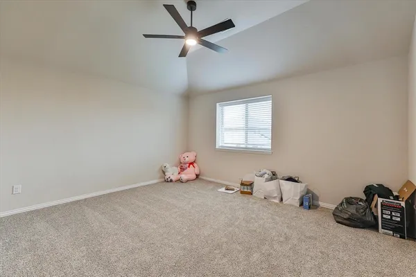 an empty room with windows and ceiling fan