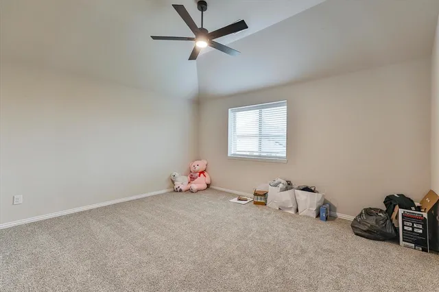 an empty room with windows and ceiling fan