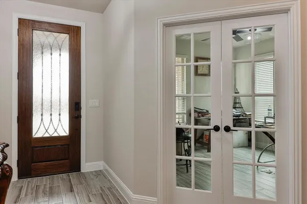 a view of a closet area with wooden floor