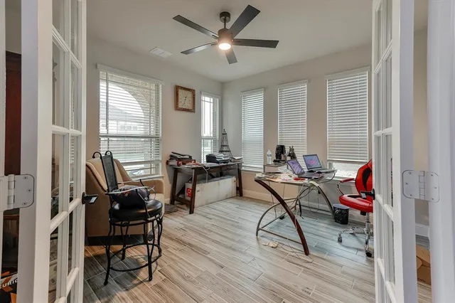 a view of a workspace with furniture and a window
