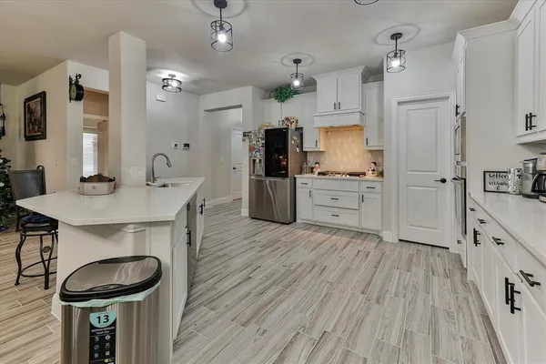 a kitchen with sink cabinets and wooden floor