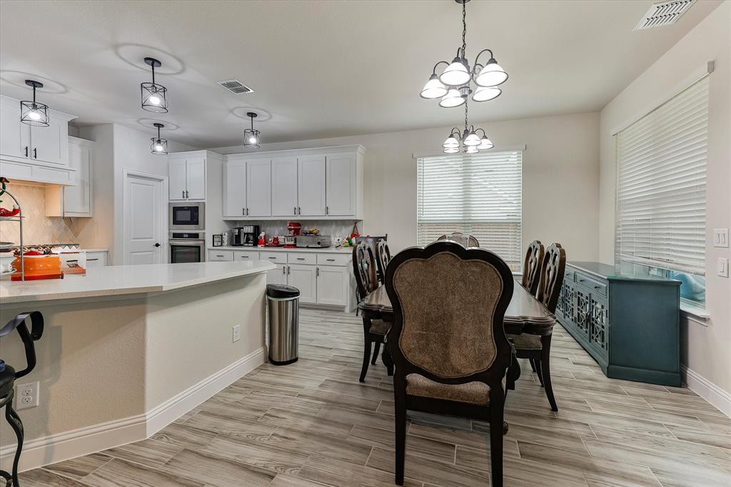 10 Covey Lane Sanger, TX 76266 - Photo 28 of 29 a kitchen that has a cabinets counter space dining table and a window