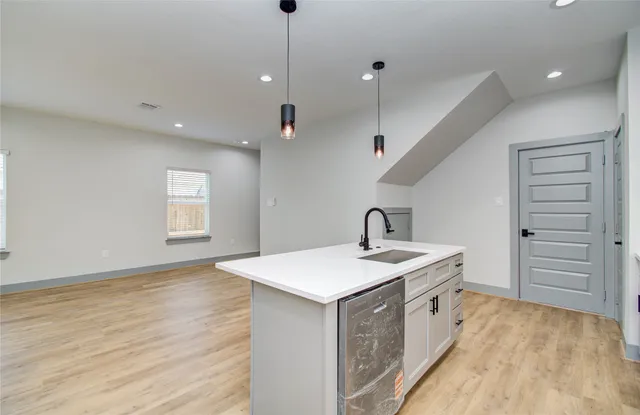 a kitchen with a sink a stove and a refrigerator