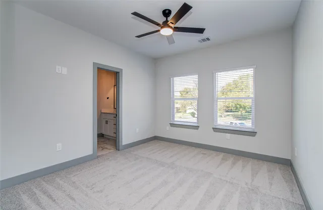 a view of room with a ceiling fan and window