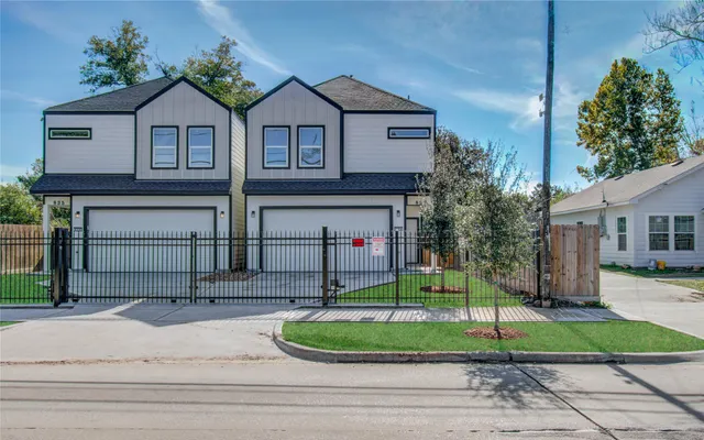 a front view of a house with a garden and plants