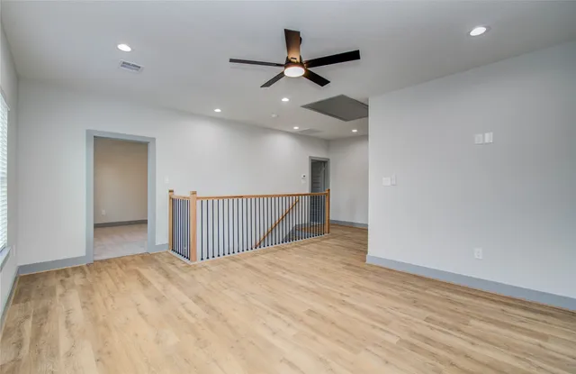 a view of an empty room with a ceiling fan
