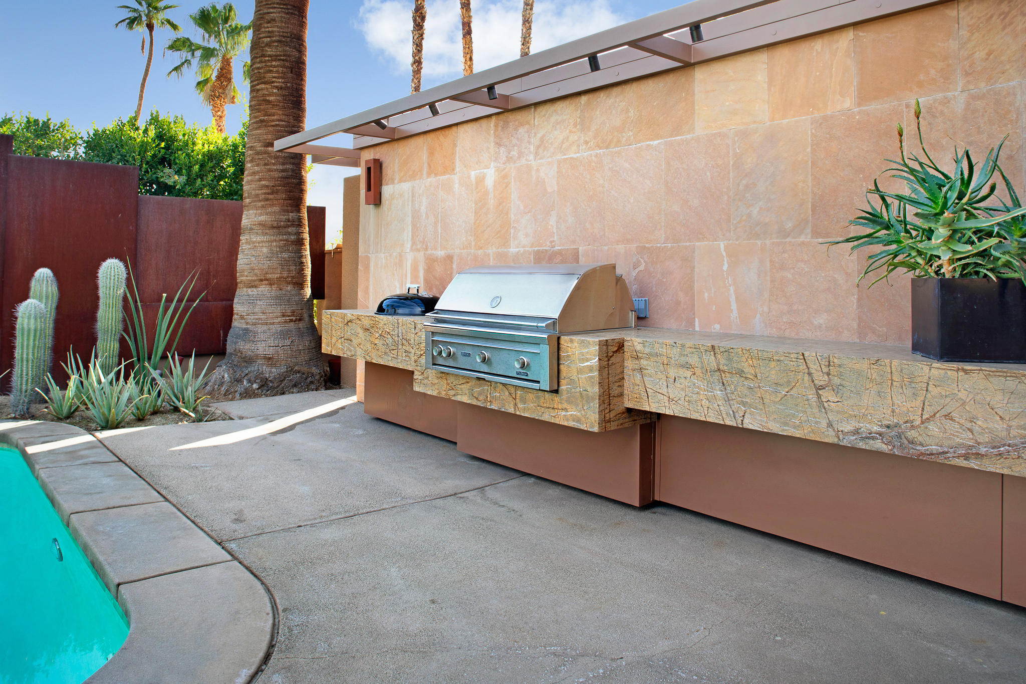 73580 Broken Arrow Trail Palm Desert, CA 92260 - Photo 11 of 40 a backyard of a house with potted plants and large tree