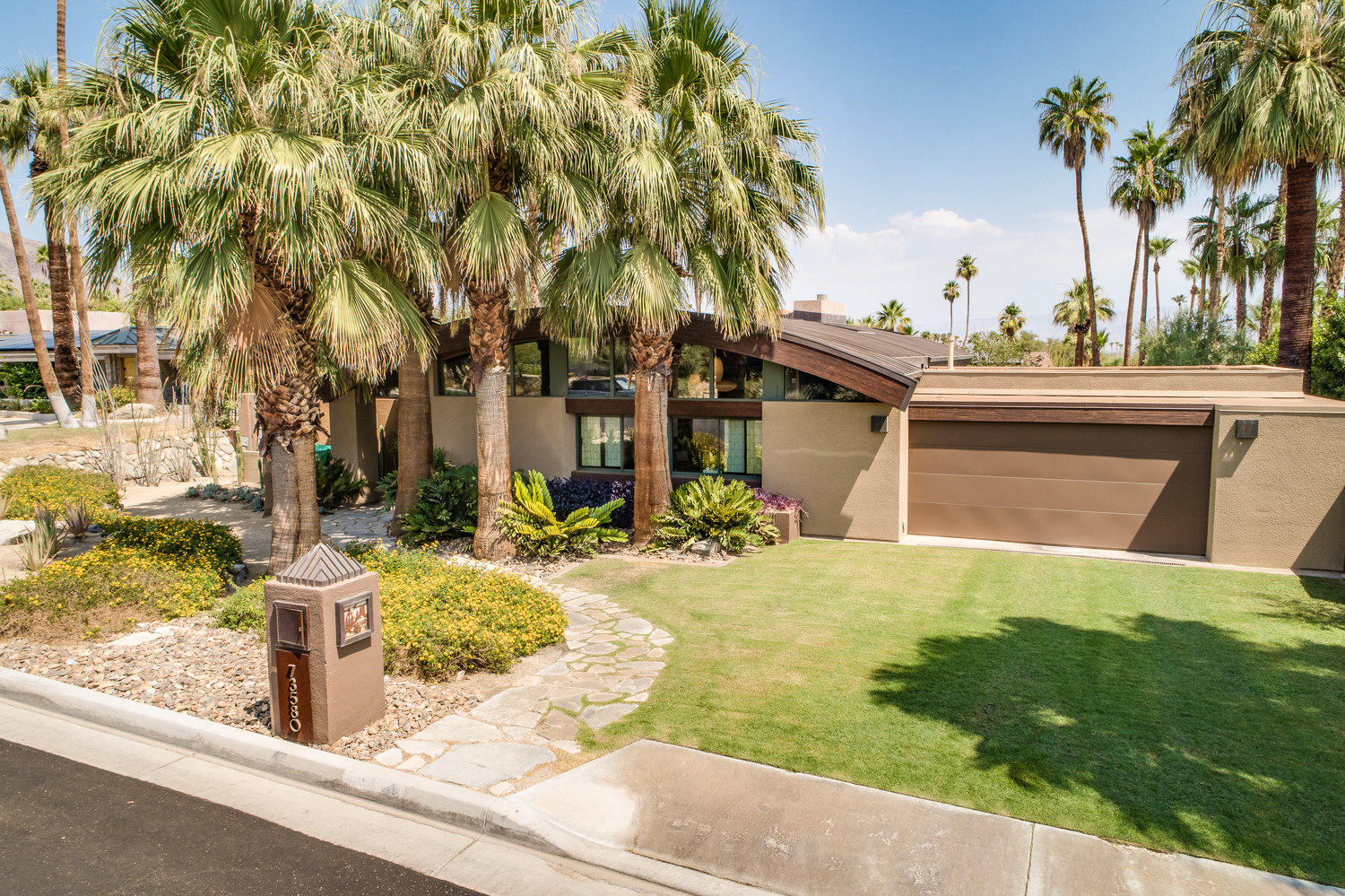 73580 Broken Arrow Trail Palm Desert, CA 92260 - Photo 4 of 40 front view of house with a yard and palm trees