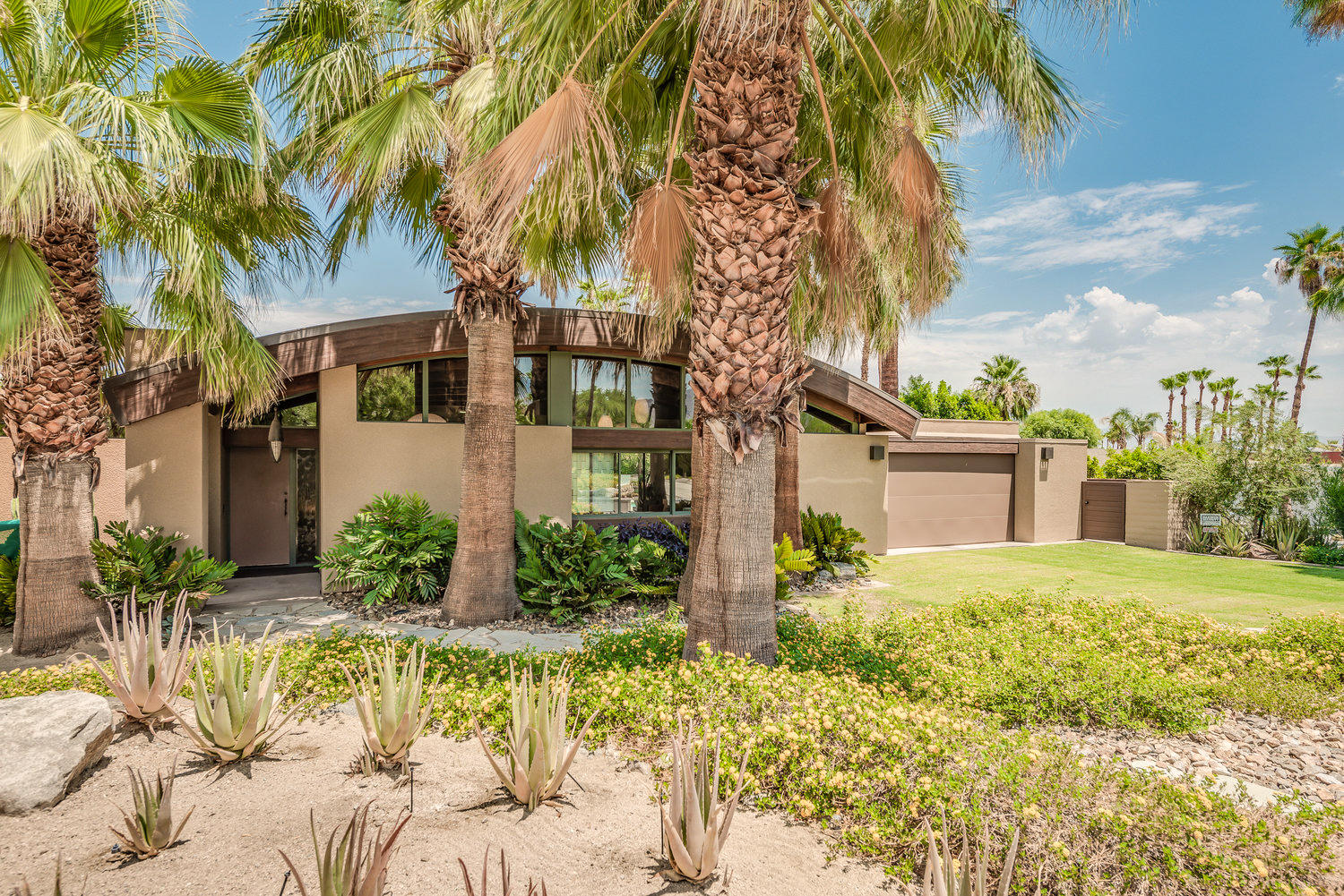 73580 Broken Arrow Trail Palm Desert, CA 92260 - Photo 5 of 40 front view of a house with a yard