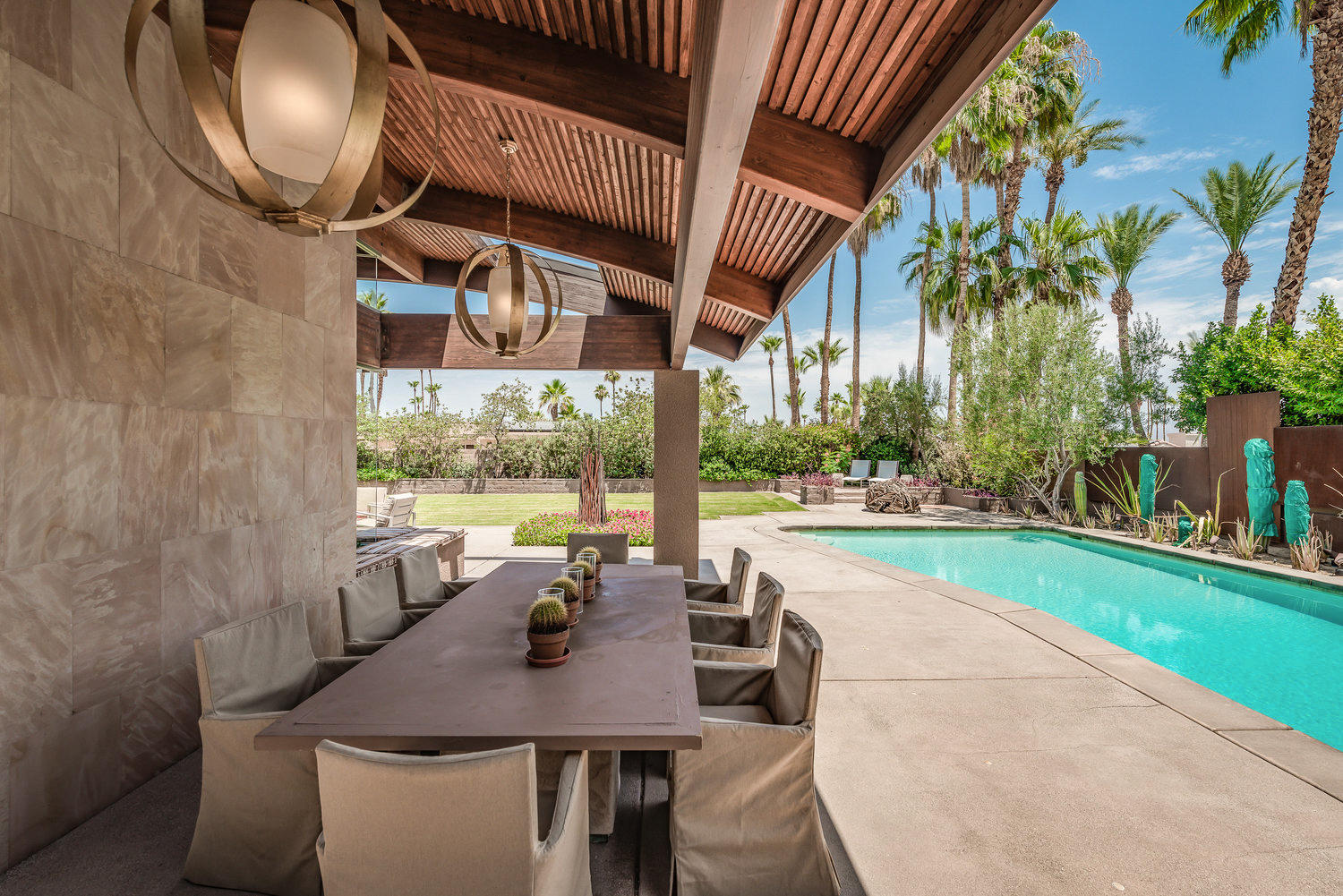 73580 Broken Arrow Trail Palm Desert, CA 92260 - Photo 9 of 40 a view of a patio with table and chairs potted plants with wooden floor