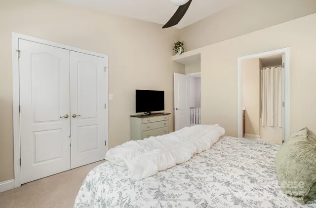a bedroom with a bed and a flat screen tv