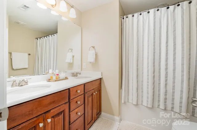 a bathroom with a double vanity sink and a mirror