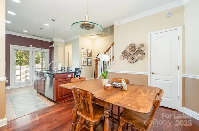 a dining room with furniture and wooden floor