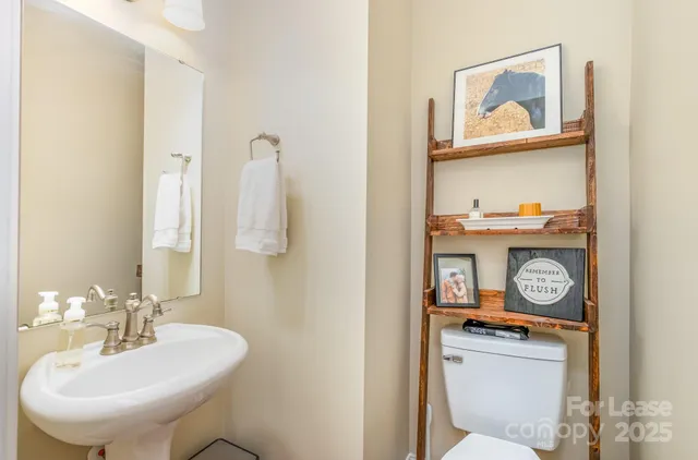a bathroom with a toilet a sink and a mirror