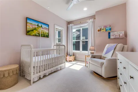 a bedroom with furniture and a large window