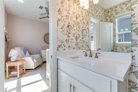 a en suite bathroom with a sink and a mirror
