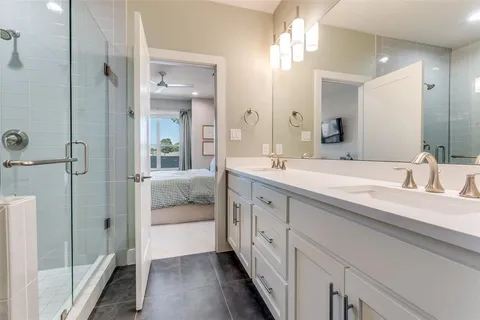 a en suite bathroom with a double sink and mirror