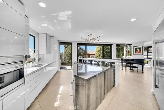 a large kitchen with kitchen island a sink and a stove top oven