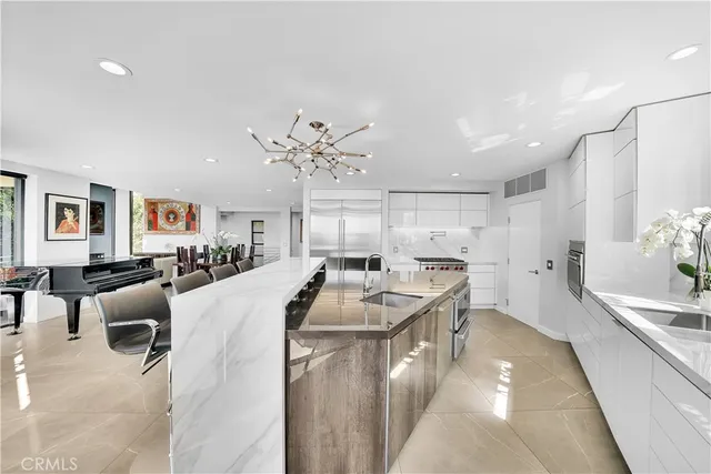 a very nice looking open dining room with kitchen island